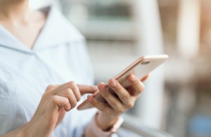 woman using smartphone on staircase in public areas, During leisure time. The concept of using the phone is essential in everyday life.